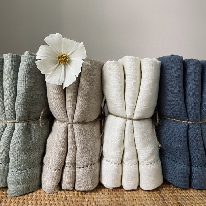 Assorted Edith muslin cloths tied and arranged in a row